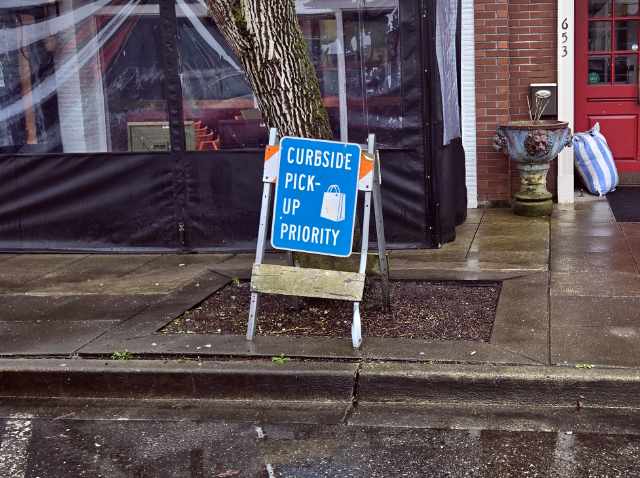 Curbside pickup priority sign outside Piacere Trattoria